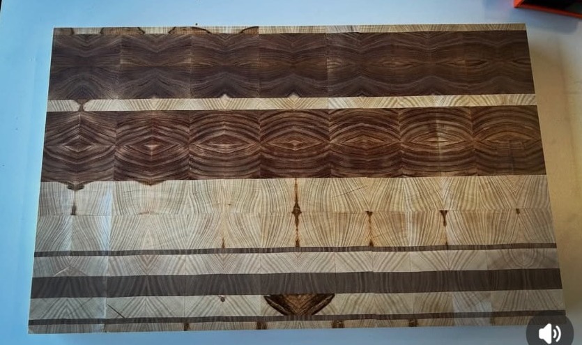Large end grain cutting board with alternating walnut and ash stripes
