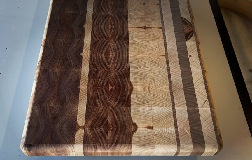 Close-up of an end grain board showing walnut and maple stripe pattern and eased edges